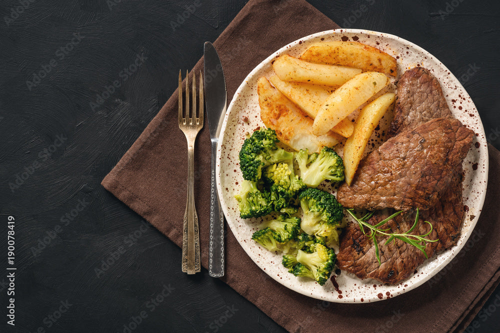 Grilled beef with baked potatoes, wedges and broccoli
